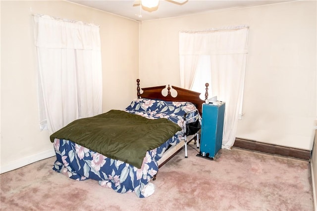 carpeted bedroom with a ceiling fan and baseboards