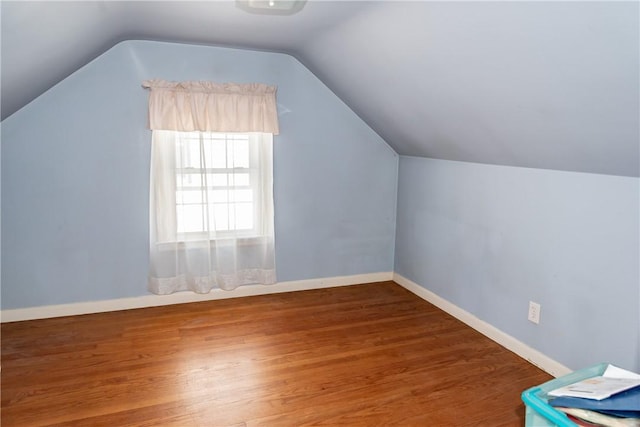 bonus room featuring vaulted ceiling, wood finished floors, and baseboards