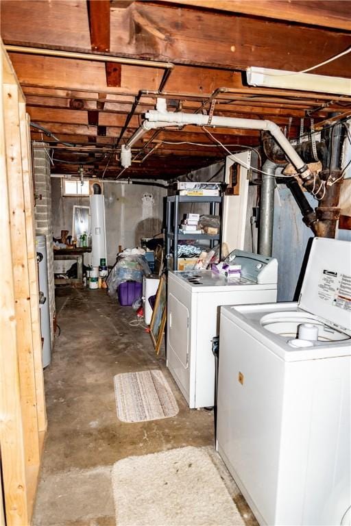 basement featuring water heater and separate washer and dryer