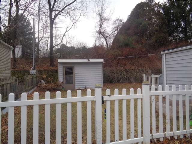 view of yard featuring a fenced front yard and an outbuilding