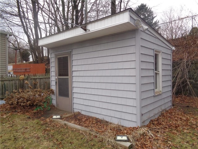 view of outbuilding featuring an outbuilding and fence