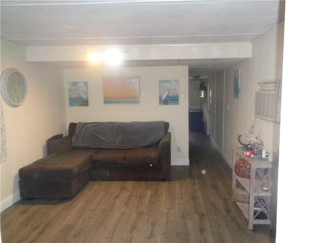 living area with baseboards and wood finished floors