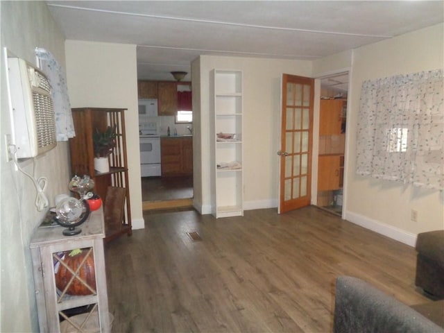 living room featuring wood finished floors and baseboards