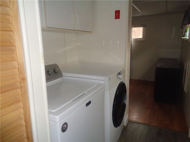 laundry area featuring laundry area, washer and dryer, and wood finished floors