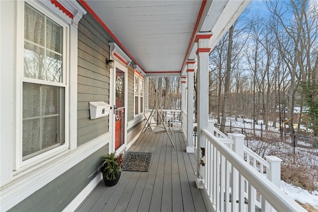 snow covered deck with fence