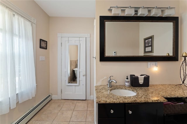 bathroom featuring a baseboard heating unit, vanity, and tile patterned floors