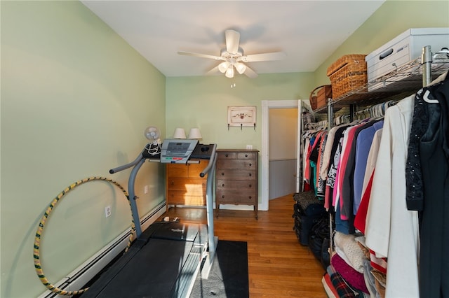 workout room featuring ceiling fan and wood finished floors