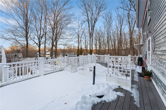 yard covered in snow with a wooden deck