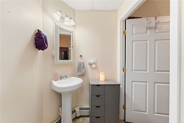 bathroom with a sink and a drop ceiling