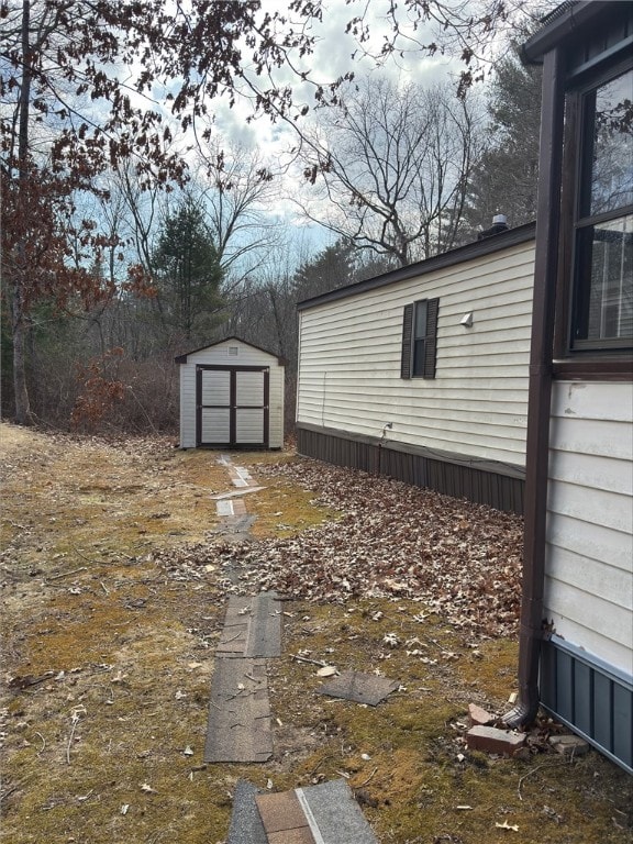 view of yard with a shed and an outbuilding