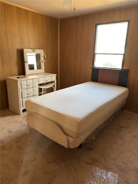 bedroom featuring carpet and wooden walls