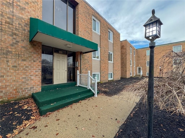 exterior space with brick siding