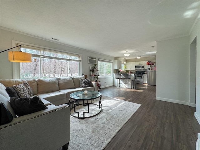 living area with dark wood-type flooring, visible vents, ornamental molding, and baseboards