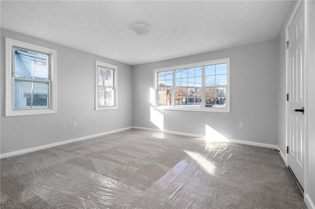 unfurnished bedroom with carpet flooring and baseboards