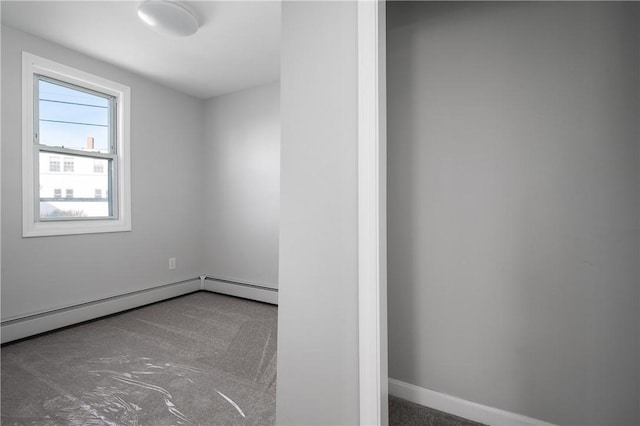 empty room featuring baseboard heating and baseboards