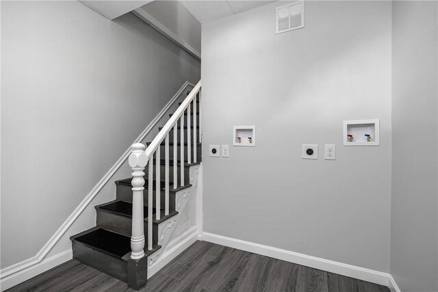 stairway with visible vents, baseboards, and wood finished floors