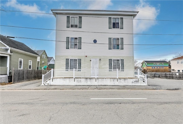 view of front facade featuring a porch and fence