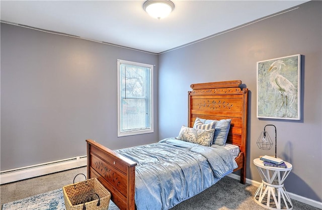 bedroom featuring a baseboard heating unit, carpet flooring, and baseboards