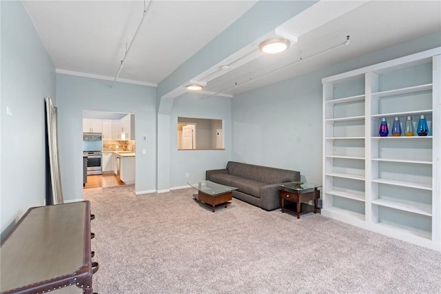 living area featuring light carpet and baseboards