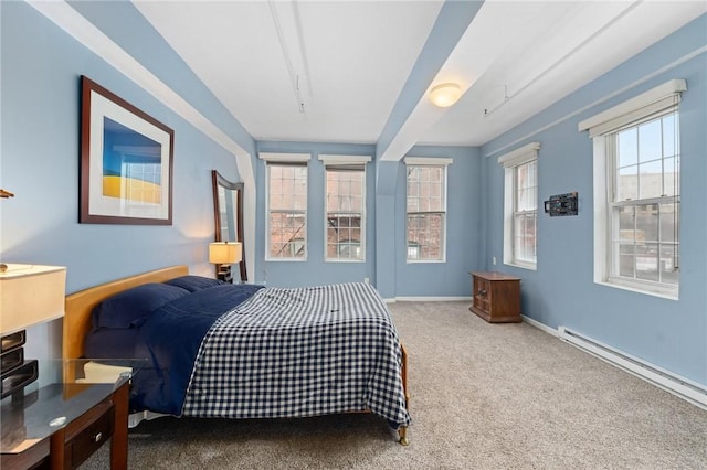 carpeted bedroom featuring a baseboard radiator and baseboards