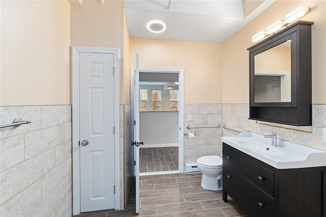 bathroom featuring wood tiled floor, toilet, tile walls, and baseboard heating