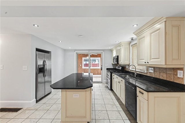 kitchen with a center island, cream cabinetry, stainless steel appliances, tasteful backsplash, and a sink