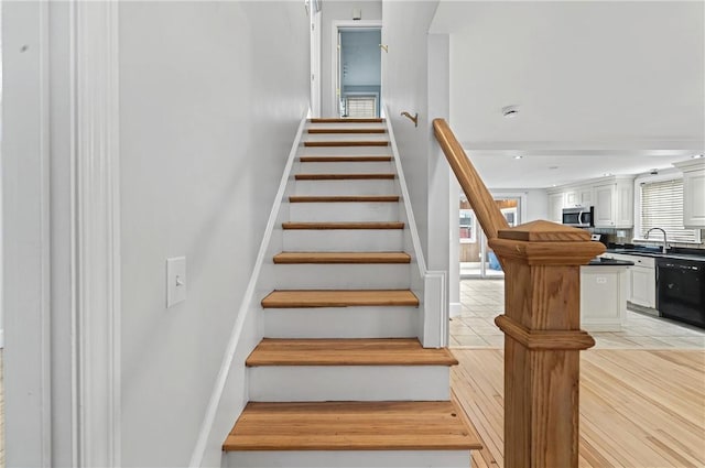 staircase featuring wood finished floors