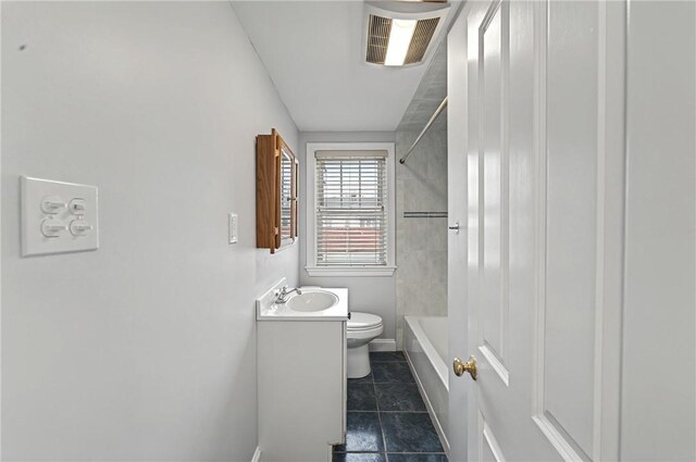 full bath featuring toilet, visible vents, vanity, tile patterned floors, and washtub / shower combination