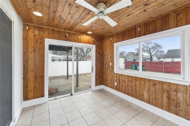 unfurnished sunroom with ceiling fan and wood ceiling