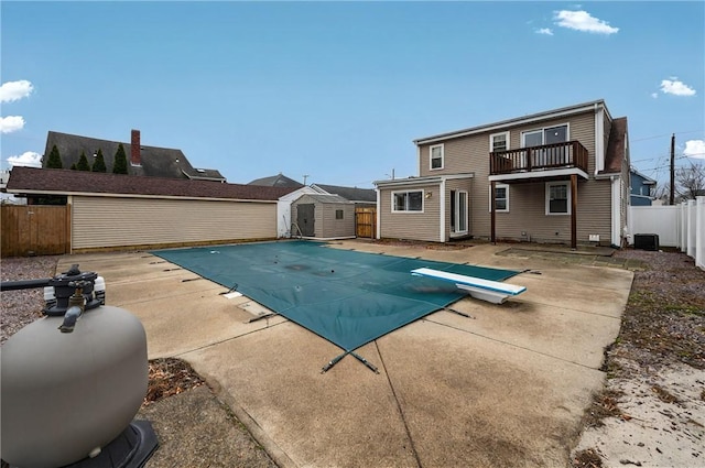 view of pool with a fenced in pool, an outbuilding, a patio, a storage shed, and a fenced backyard