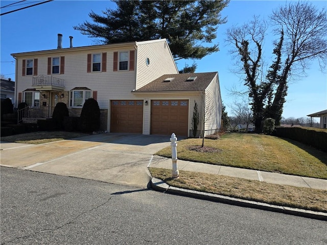 view of front of property with concrete driveway and a front lawn