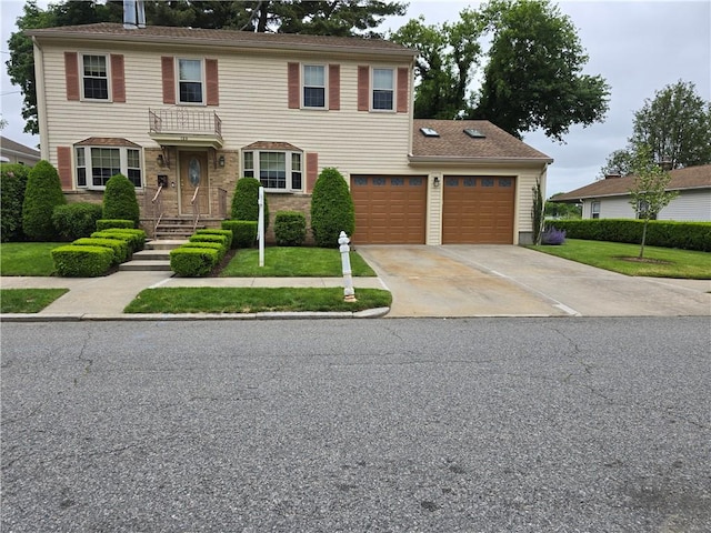 129 Longwood Ave, Providence, RI 02908 - view of front of house with driveway, a front yard, and a garage