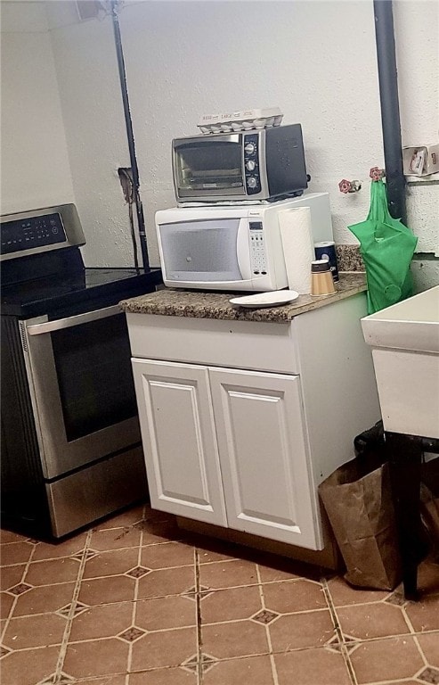 interior space with stainless steel appliances, a sink, and white cabinetry