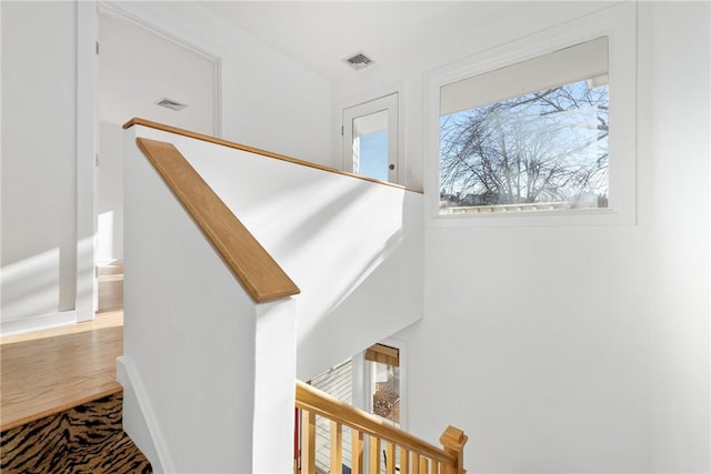 staircase featuring visible vents