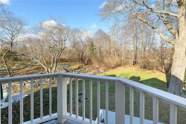 wooden deck featuring a yard