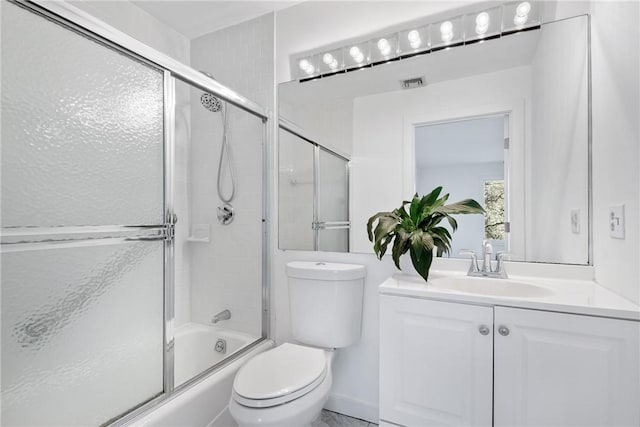 full bathroom featuring visible vents, shower / bath combination with glass door, vanity, and toilet