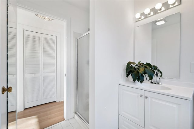 bathroom with visible vents, a stall shower, a closet, and vanity