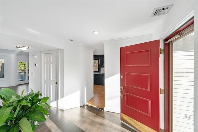 entrance foyer featuring ornamental molding, wood finished floors, visible vents, and recessed lighting