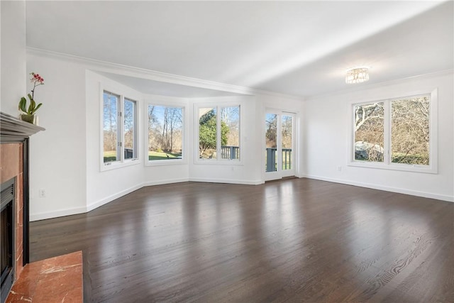 unfurnished living room with a fireplace with flush hearth, dark wood finished floors, baseboards, and ornamental molding