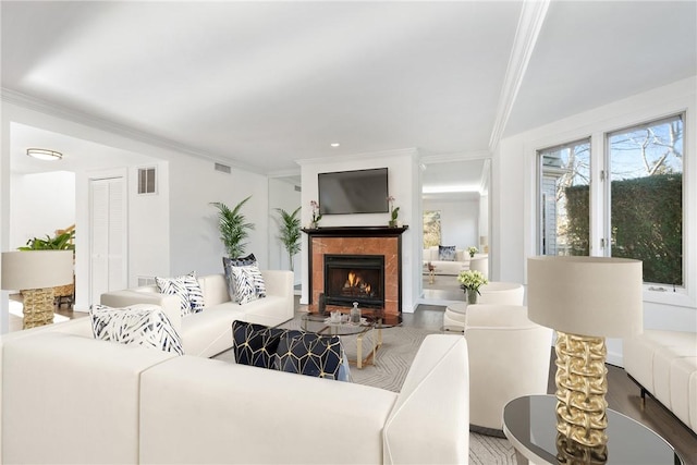 living area featuring a lit fireplace, ornamental molding, and visible vents