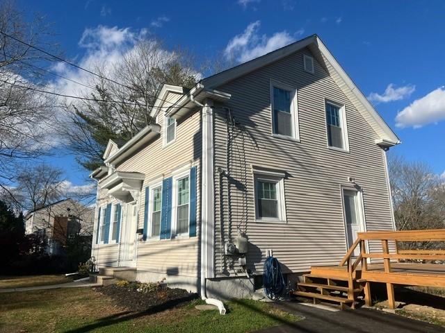 view of side of property featuring a wooden deck