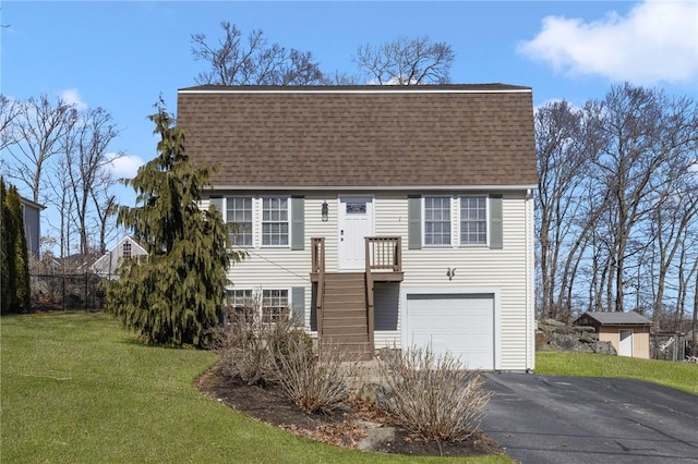 view of front facade featuring a garage, a shingled roof, stairs, driveway, and a front yard