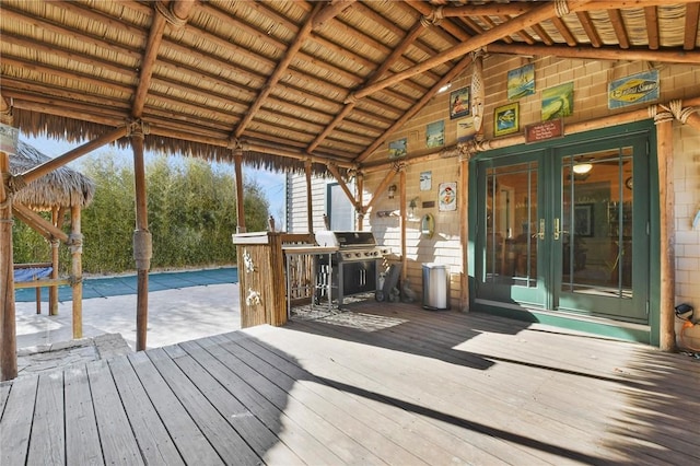 wooden deck with area for grilling and french doors