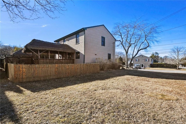 view of property exterior with fence