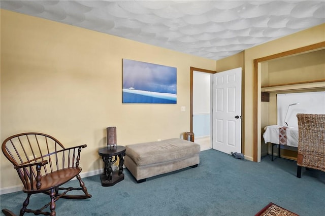 living area featuring baseboards and carpet