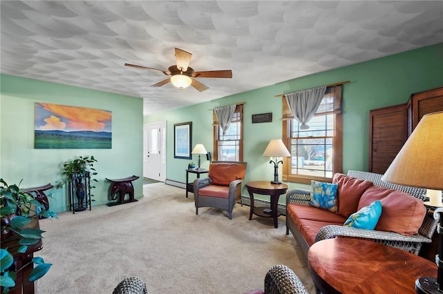 living room with carpet flooring, baseboard heating, and ceiling fan