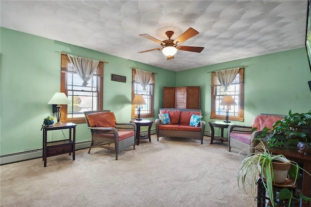 carpeted living room with ceiling fan and a baseboard radiator