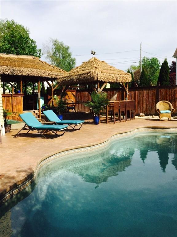 view of swimming pool with a gazebo, a fenced backyard, a fenced in pool, and a patio