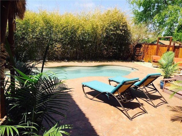 view of pool with a patio area, a fenced in pool, and fence