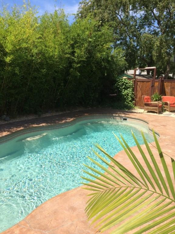 view of swimming pool featuring fence, a patio area, and a fenced in pool